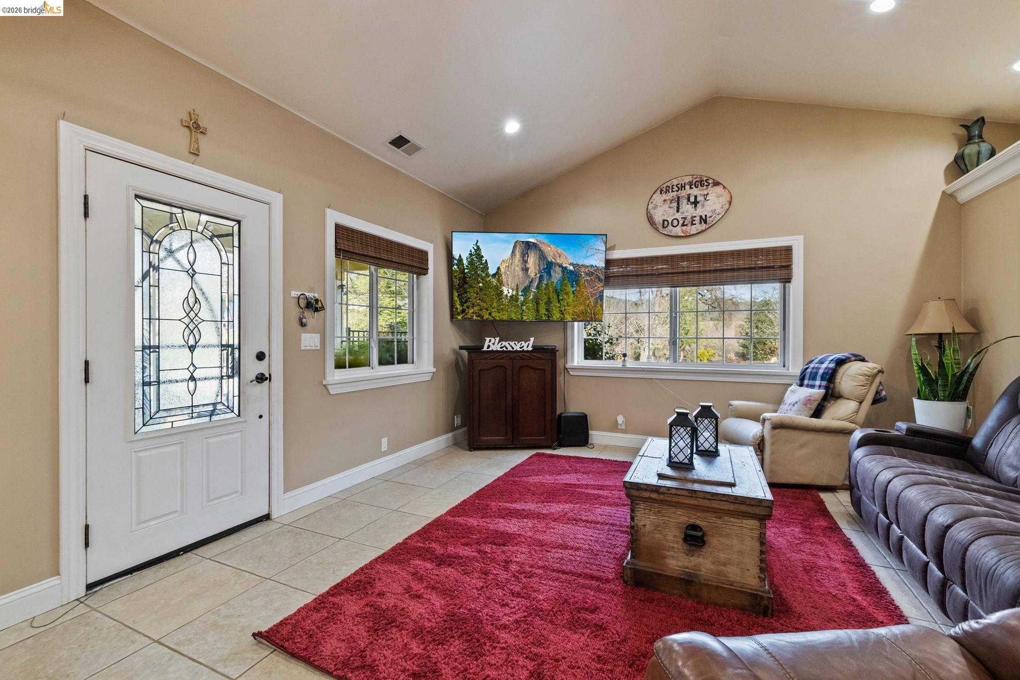 10177 Pulpit Rock Road Jamestown, CA 95327 - Photo 5 of 60 Living area with light tile patterned flooring, healthy amount of natural light, vaulted ceiling, and recessed lighting