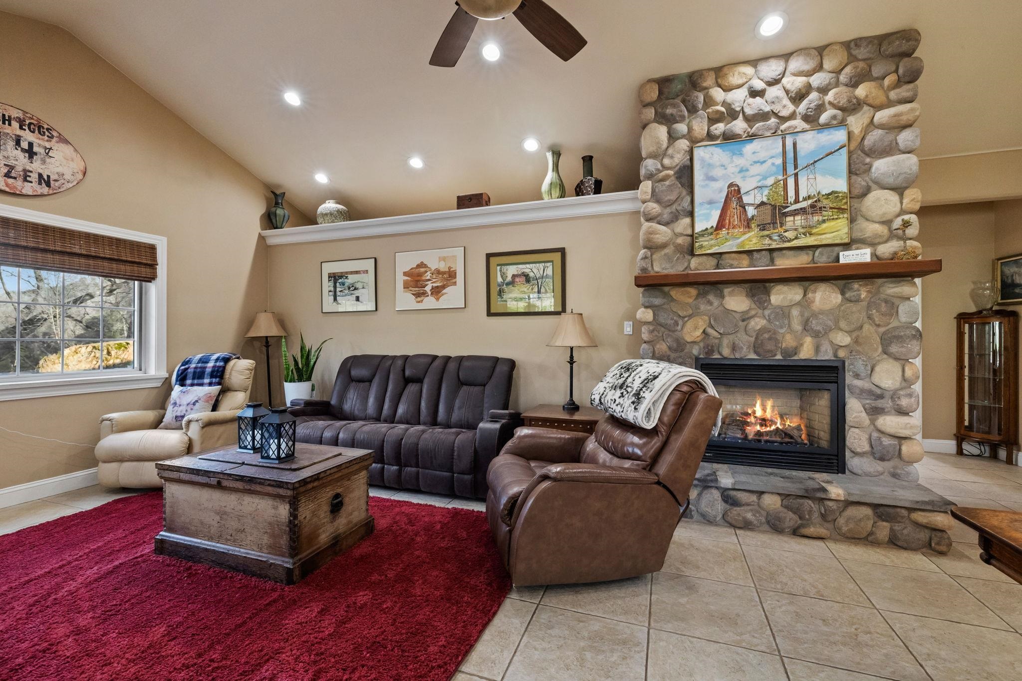 10177 Pulpit Rock Road Jamestown, CA 95327 - Photo 5 of 60 Living room featuring light tile patterned floors, a fireplace, recessed lighting, a ceiling fan, and high vaulted ceiling