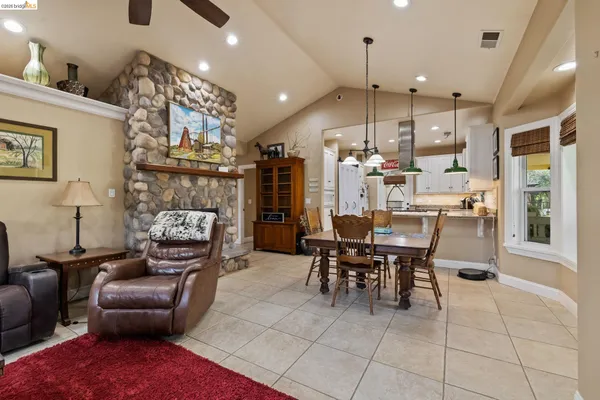 a kitchen with granite countertop white cabinets and stainless steel appliances