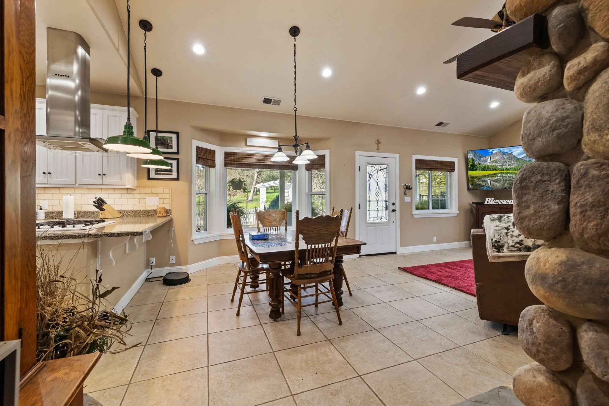 10177 Pulpit Rock Road Jamestown, CA 95327 - Photo 10 of 60 Dining space with recessed lighting, light tile patterned flooring, and vaulted ceiling