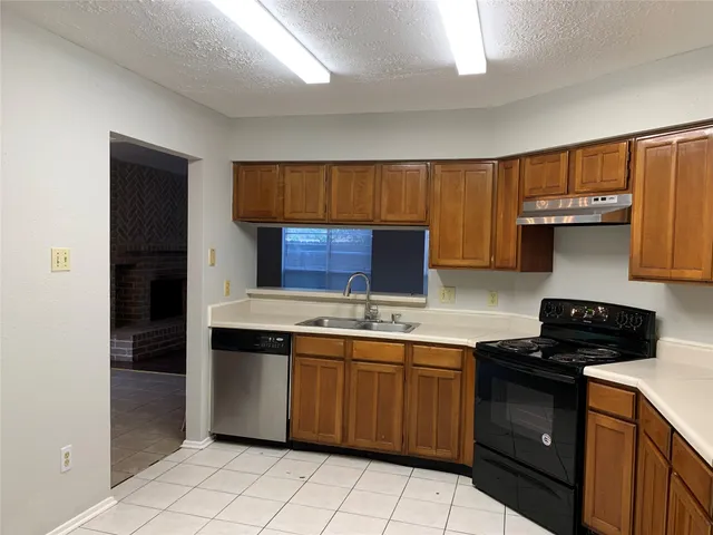 a kitchen with a sink and a stove top oven