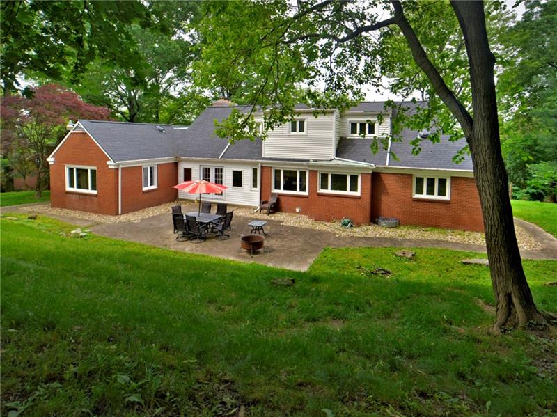 43 Holland Road Churchill, PA 15235 - Photo 25 of 25 Back view of home with large patio. Yard levels off up top. Private setting.