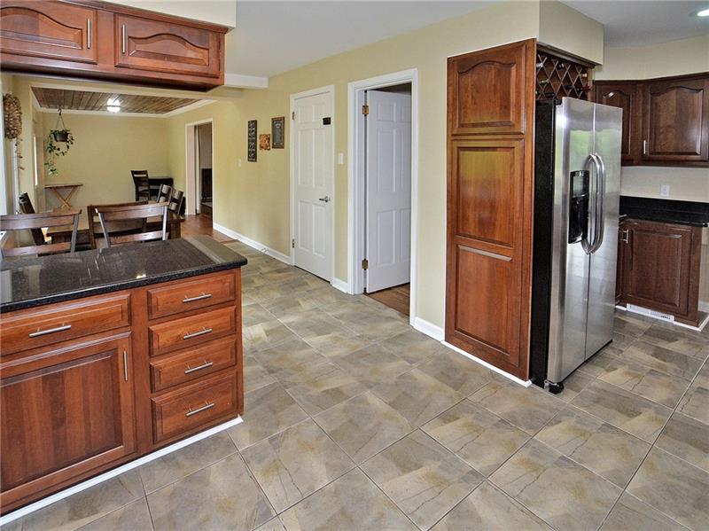 43 Holland Road Churchill, PA 15235 - Photo 5 of 25 Kitchen area with SS appliances, and view of the seating area, and bonus room off kitchen.