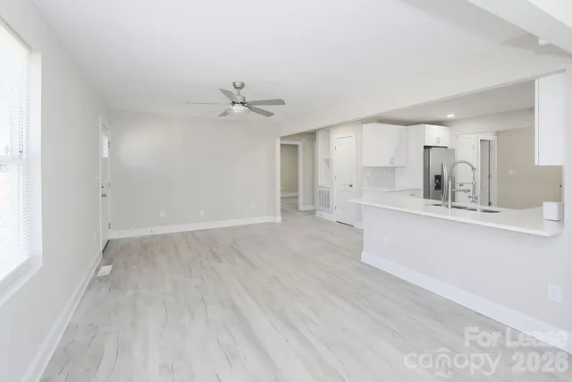a view of kitchen with granite countertop cabinets and sink