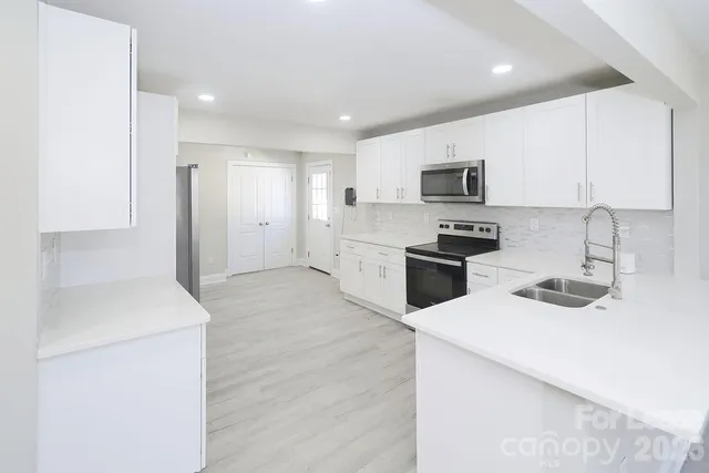 a kitchen with a sink stove and refrigerator