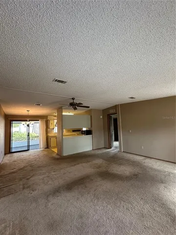 a view of a livingroom with an empty space and a window
