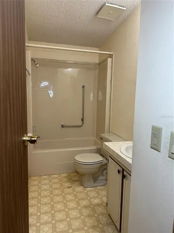 a bathroom with a toilet a sink and shower
