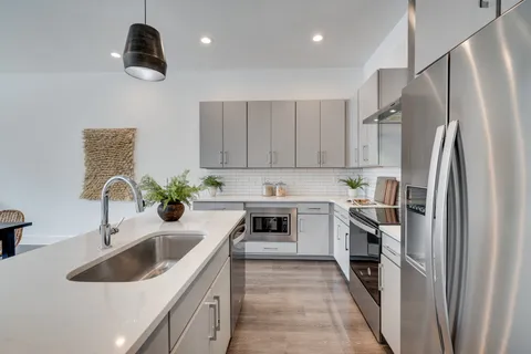 a kitchen with a sink stainless steel appliances and cabinets