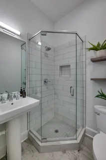 a bathroom with a shower a toilet and sink