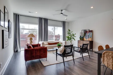 a living room with furniture and a large window