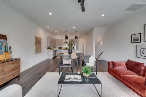a living room with furniture and wooden floor
