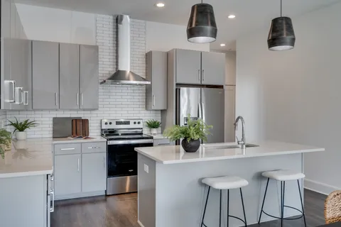 a kitchen with cabinets and stainless steel appliances