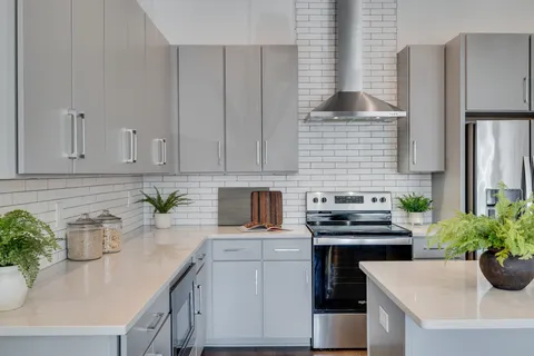 a kitchen with stainless steel appliances white cabinets and a stove