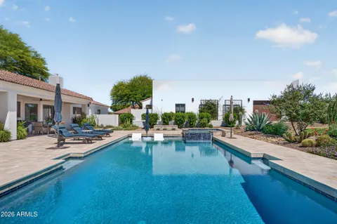 a view of a house with swimming pool and sitting area