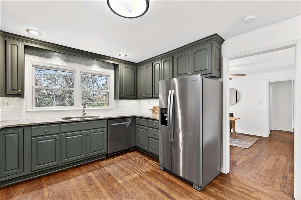 632 Willivee Drive Decatur, GA 30033 - Photo 16 of 44 a kitchen with stainless steel appliances granite countertop a refrigerator a sink a stove with wooden cabinets and floor
