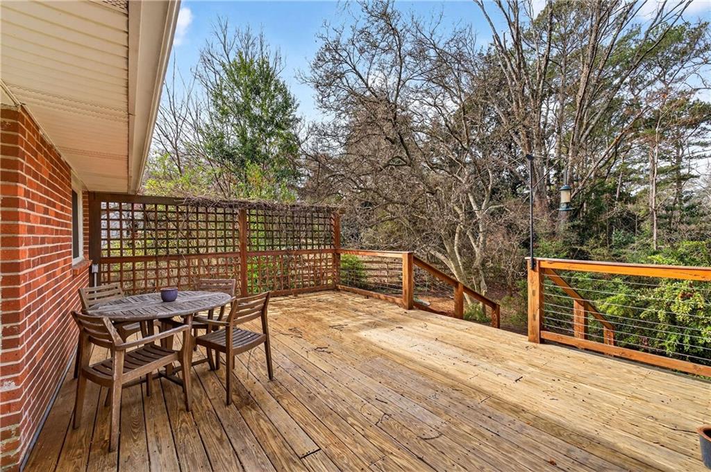 632 Willivee Drive Decatur, GA 30033 - Photo 34 of 44 a view of a roof deck with table and chairs with wooden floor and fence