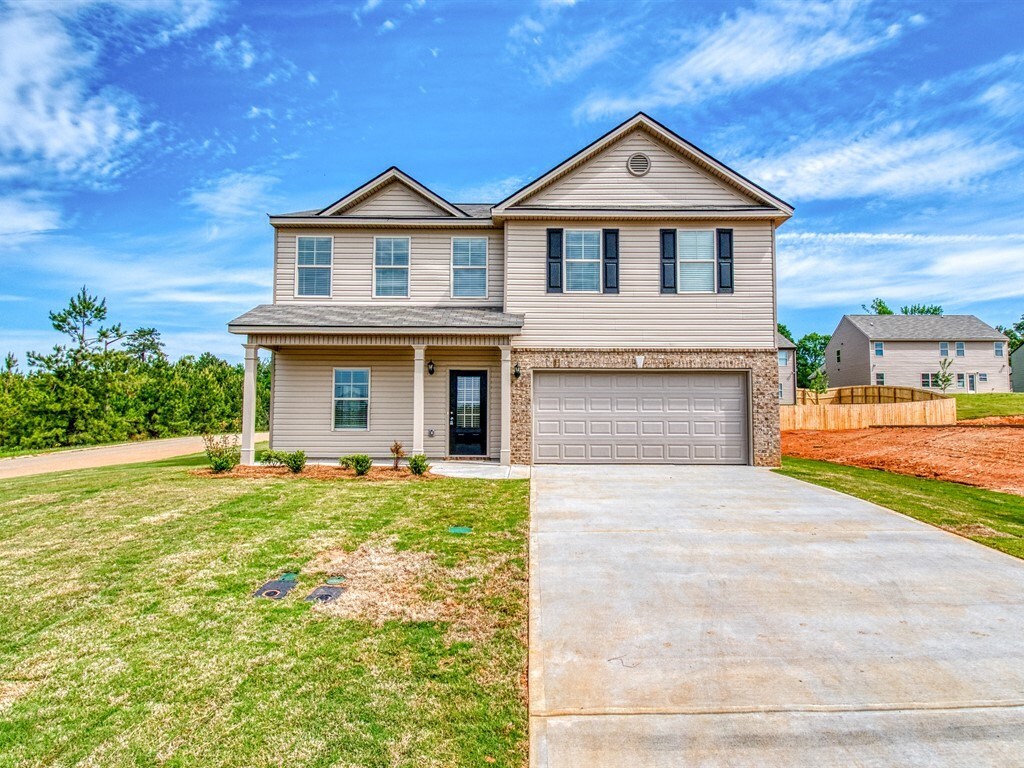 302 Longbridge Way, Unit 32EVEREST Perry, GA 31069 - Photo 1 of 1 a front view of a house with a yard and garage