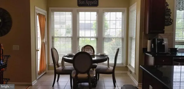 a view of a dining room with furniture and window