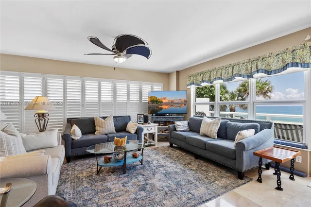 a balcony with furniture and a floor to ceiling window