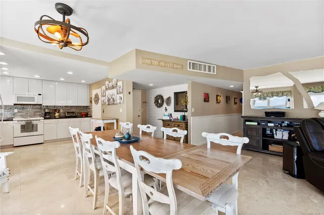 a view of a dining room with furniture and a potted plant