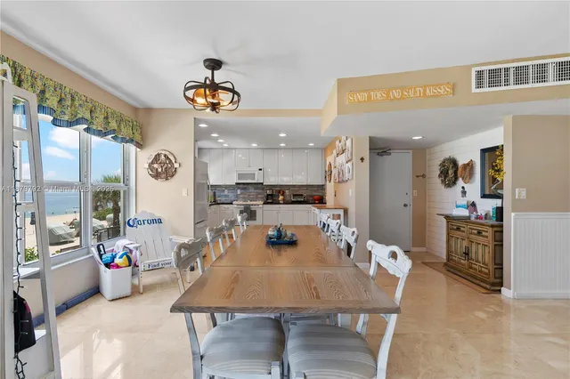 a living room with furniture and kitchen view