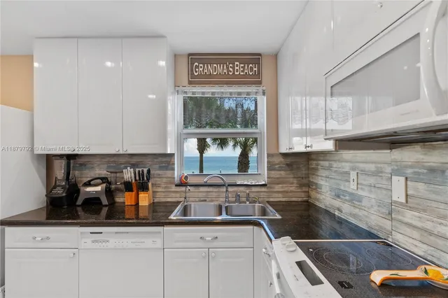 a kitchen with stainless steel appliances granite countertop a stove and a sink