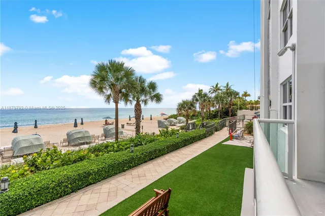 a view of a terrace with a garden and lake view