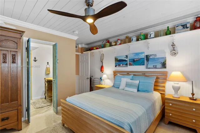 a bedroom with a bed chandelier and a window