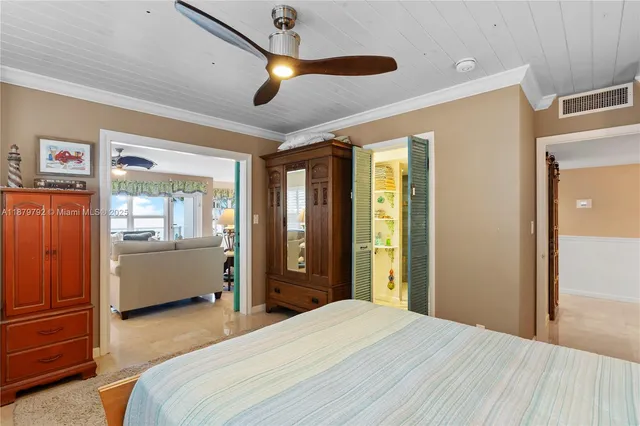 a bed room with a bed and a large window