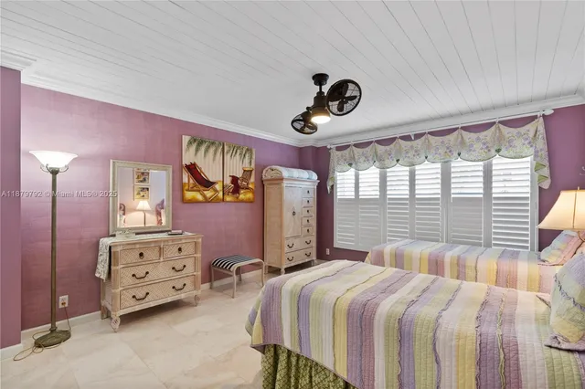 a bedroom with two beds and windows