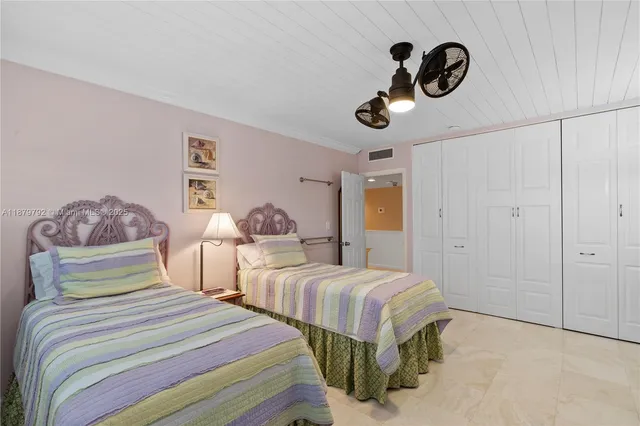 a bedroom with bed and cabinets