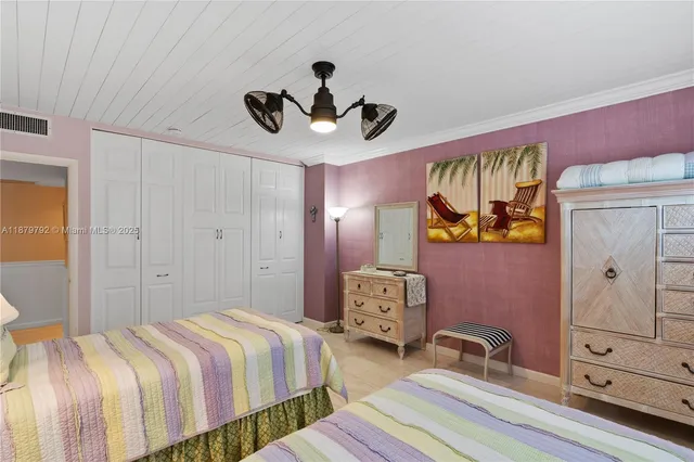 a bedroom with a bed and dresser with window