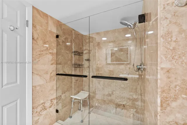 a bedroom with a large bed and a flat tv screen on dresser