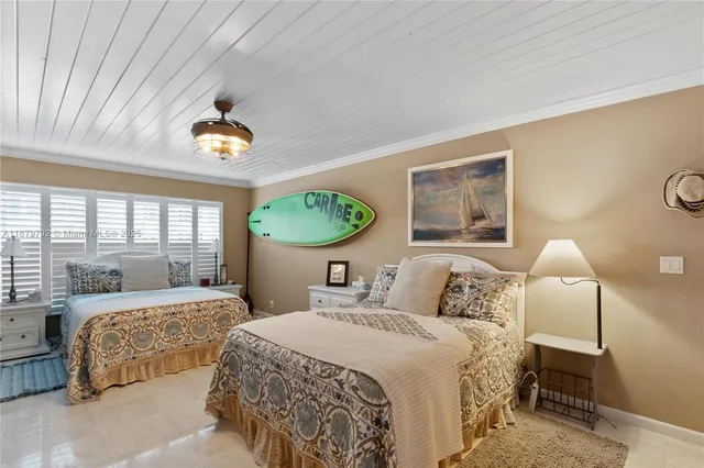 a bedroom with a bed furniture and a flat tv screen