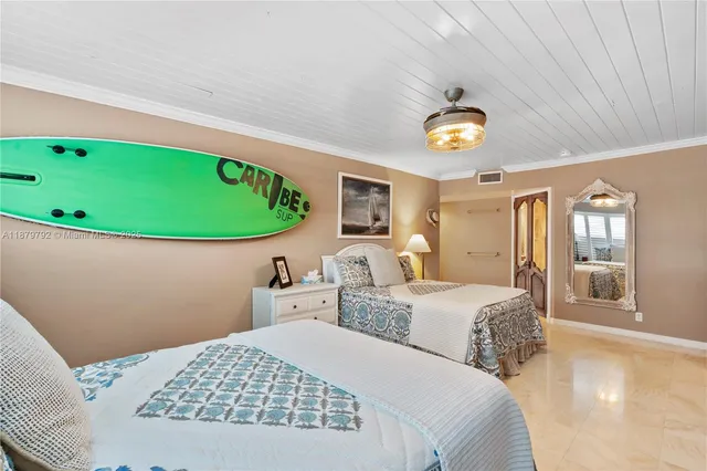 a bedroom with bed and a chandelier