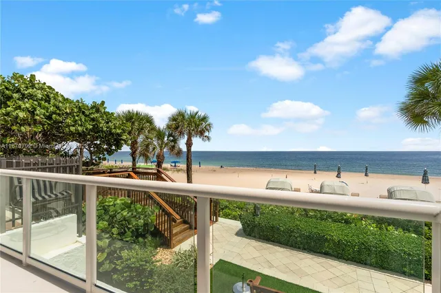 a view of a chair and tables on the balcony