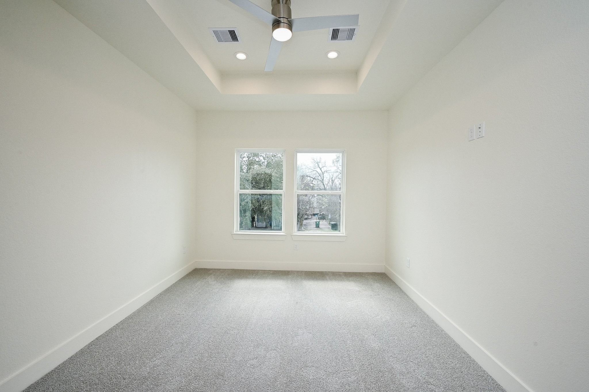 3839 Noah Street, Unit B Houston, TX 77021 - Photo 10 of 19 This room features a neutral color palette with carpeting and a large window for natural light. The ceiling has recessed lighting and a fan, offering a modern touch.