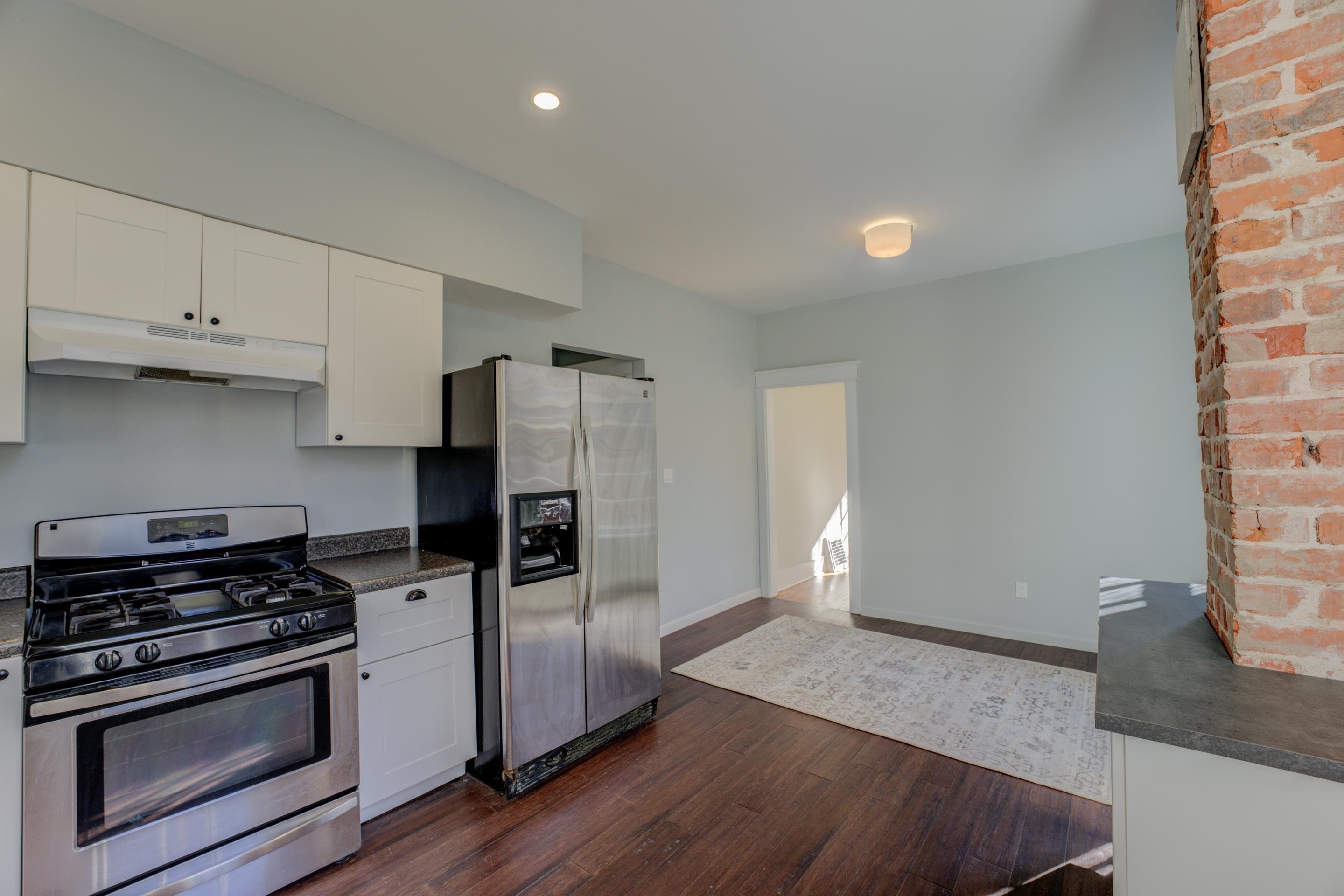 1844 Oliver Avenue Memphis, TN 38114 - Photo 12 of 18 a kitchen with granite countertop a stove and a refrigerator