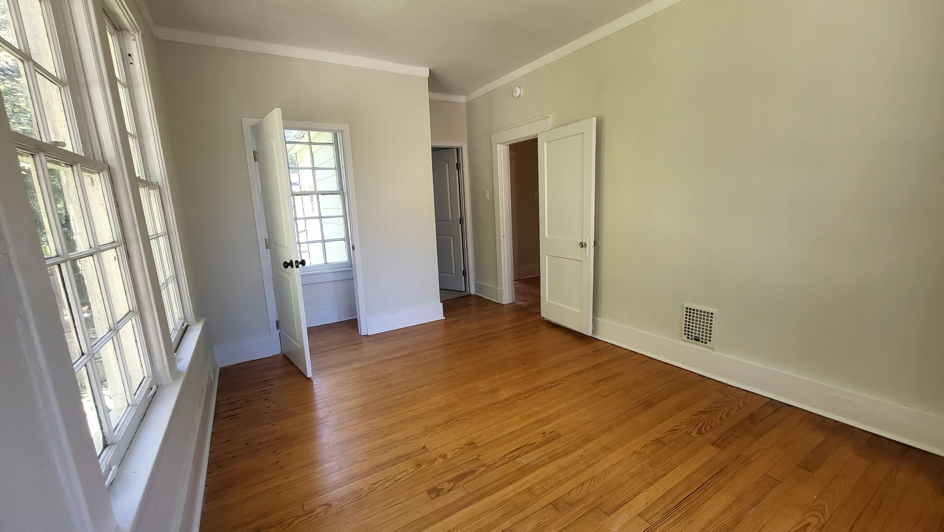 1844 Oliver Avenue Memphis, TN 38114 - Photo 13 of 18 a view of an empty room with glass door and wooden floor