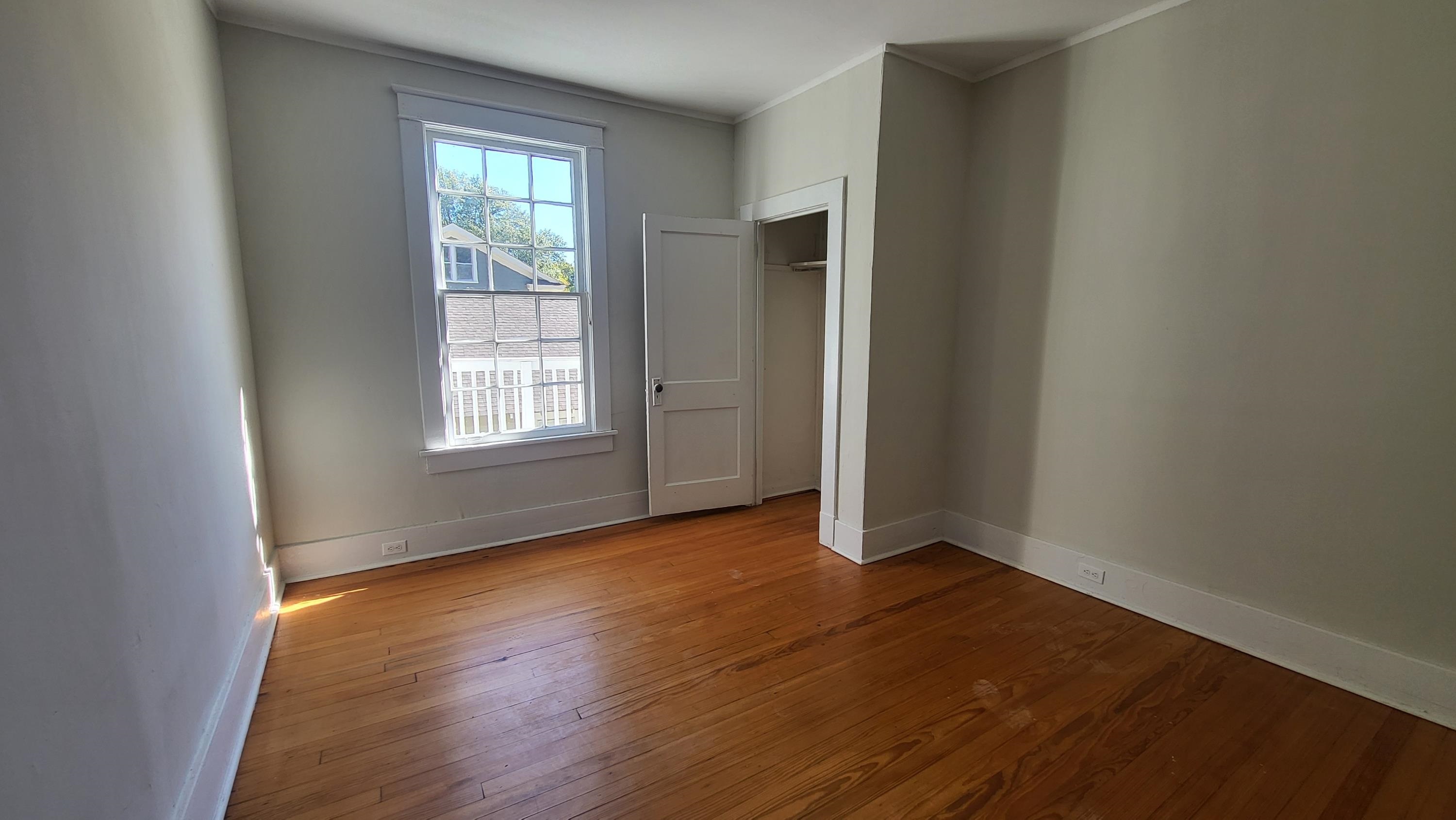 1844 Oliver Avenue Memphis, TN 38114 - Photo 16 of 18 an empty room with wooden floor and windows
