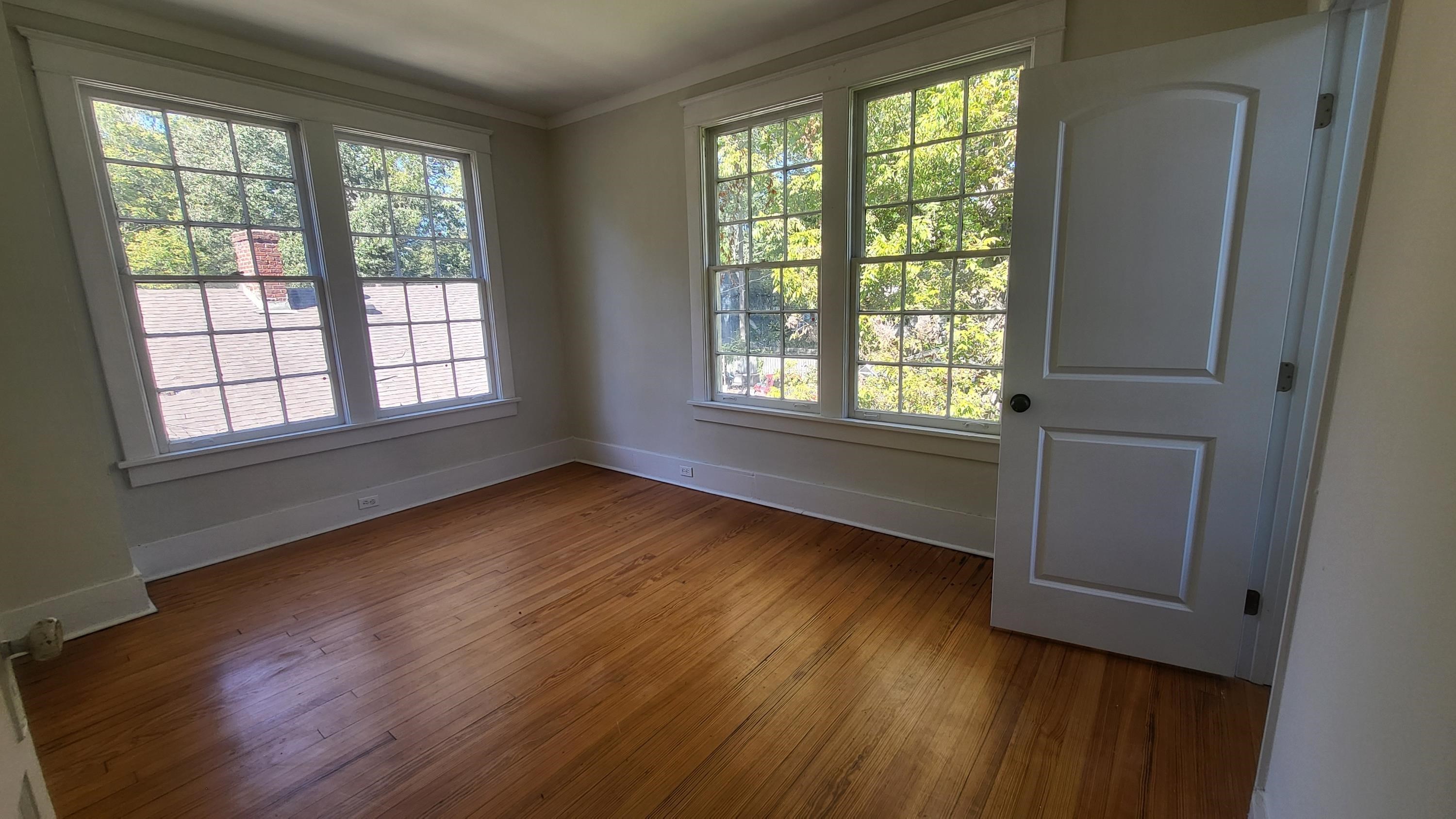1844 Oliver Avenue Memphis, TN 38114 - Photo 17 of 18 a view of an empty room with wooden floor and a window