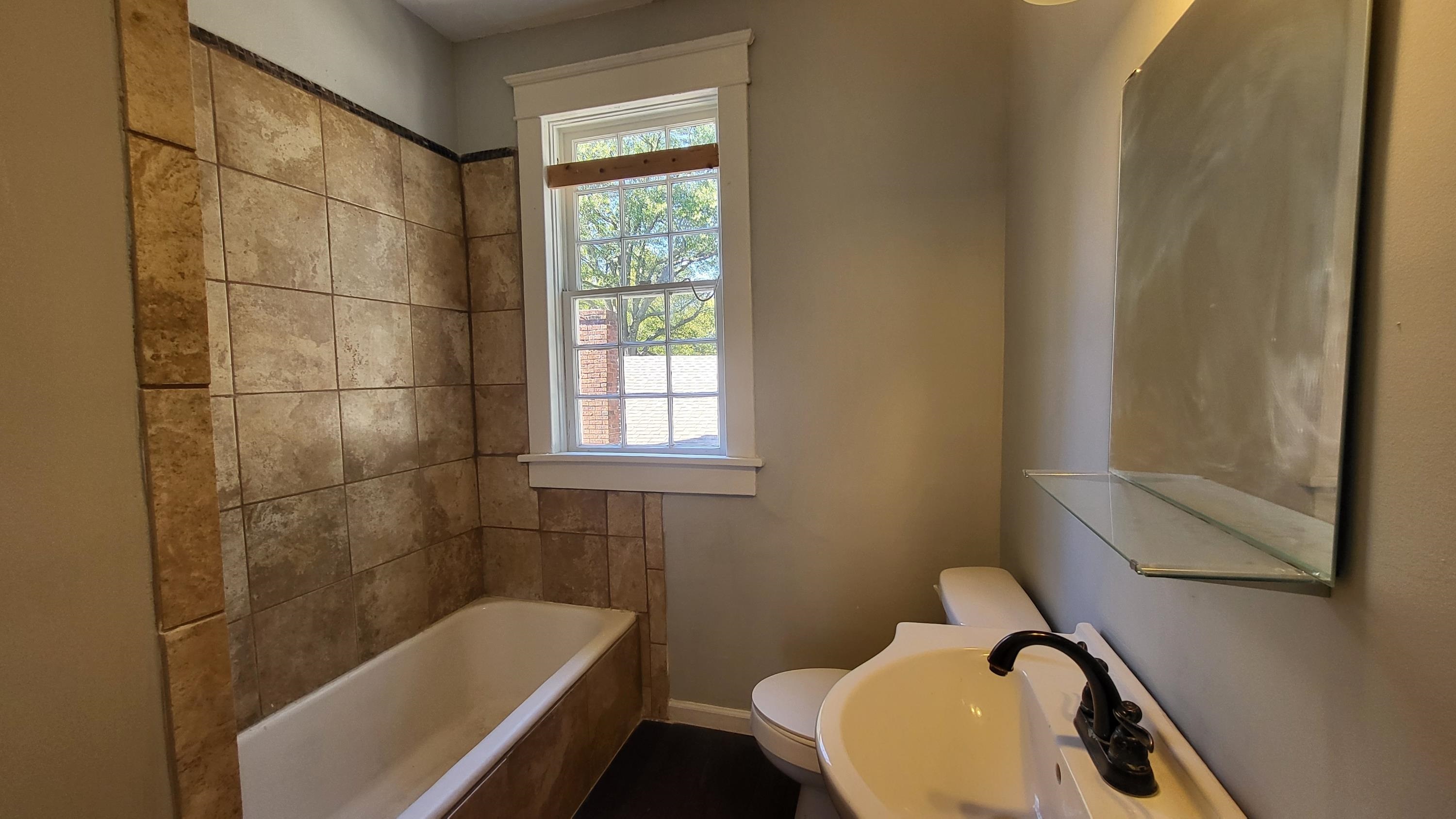 1844 Oliver Avenue Memphis, TN 38114 - Photo 18 of 18 a bathroom with a sink toilet and shower
