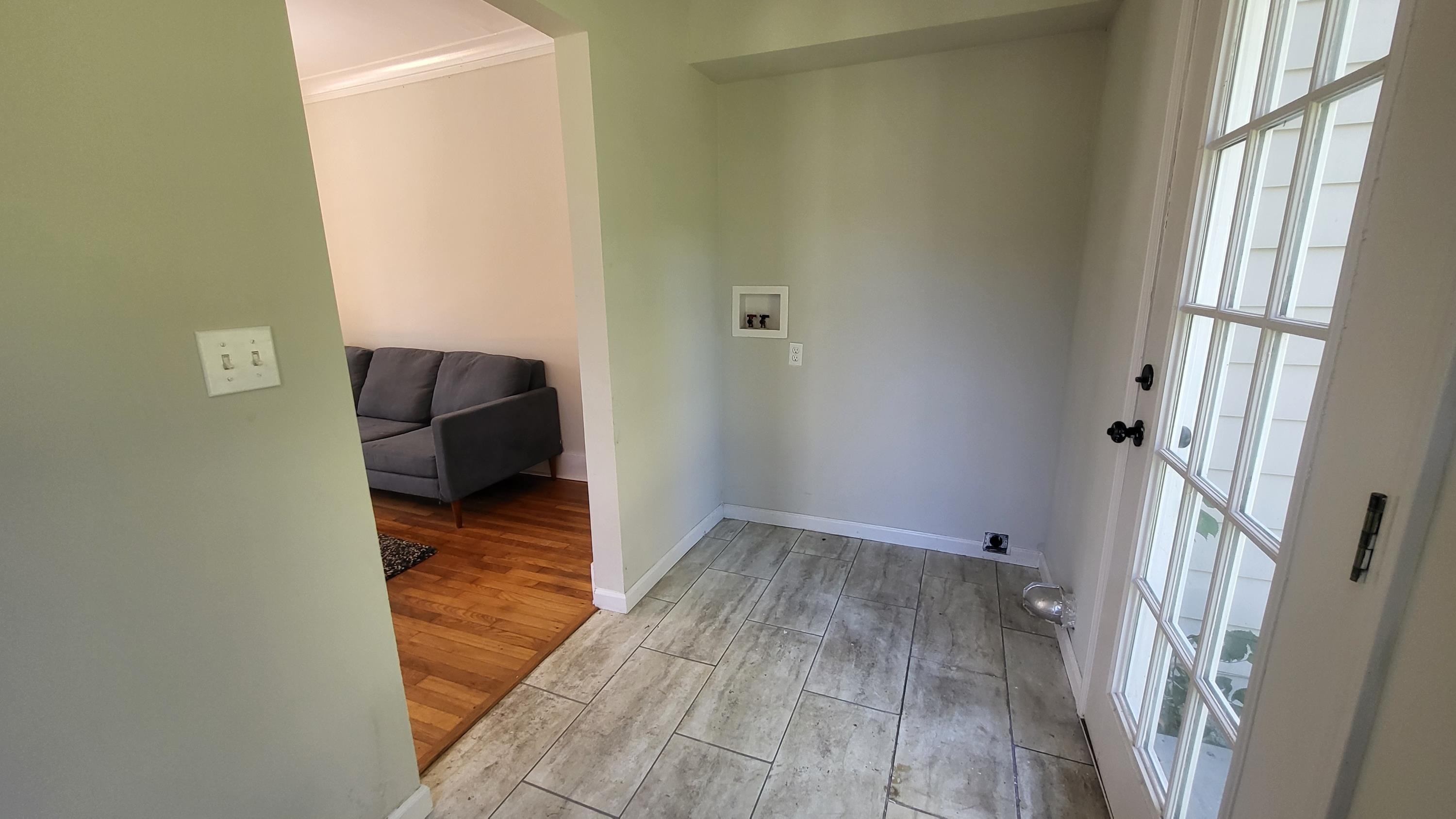 1844 Oliver Avenue Memphis, TN 38114 - Photo 10 of 18 a view of a hallway with wooden floor and a cabinet
