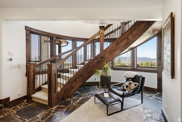 7885 North Rabbitbrush Court, Unit 13 Park City, UT 84098 - Photo 58 of 88 Curved staircase featuring rich wood accents and wrought iron balusters