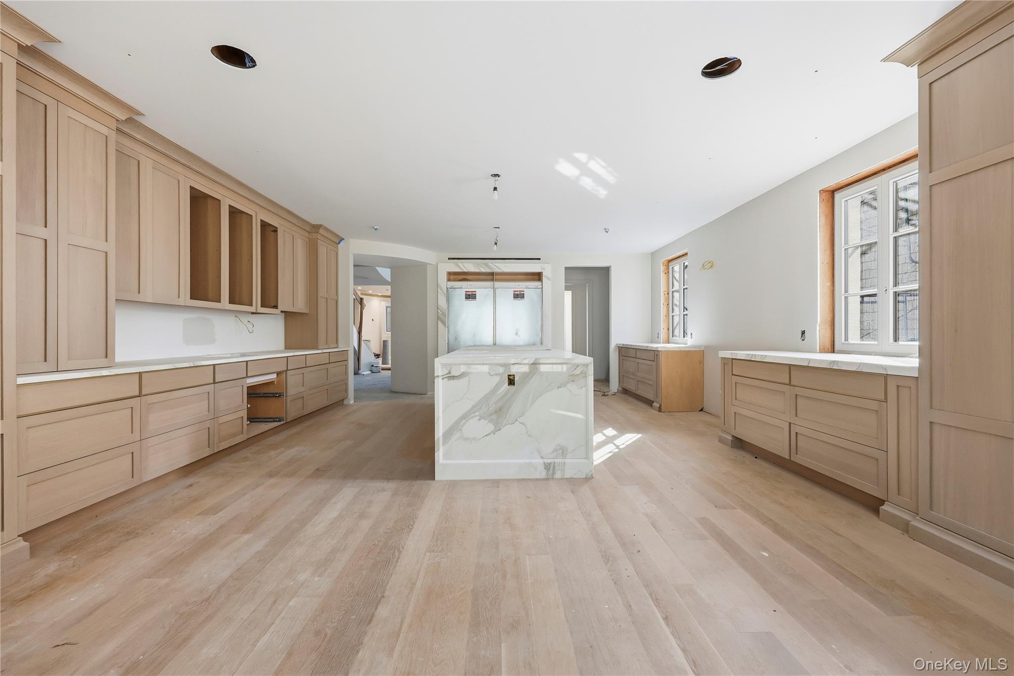 156 Harborview South Lawrence, NY 11559 - Photo 2 of 26 a large white kitchen with a lot of cabinets and wooden floor