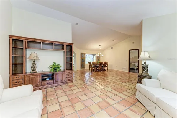 a kitchen with stainless steel appliances granite countertop a refrigerator a stove and a sink