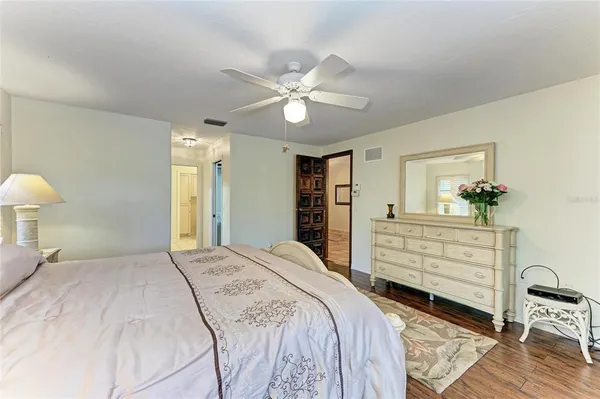 a view of a room with a ceiling fan and window