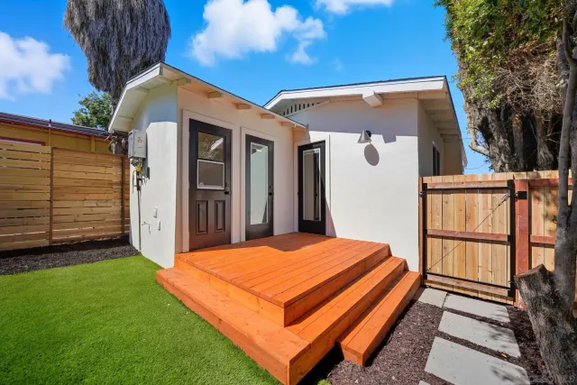 a view of backyard of house and deck