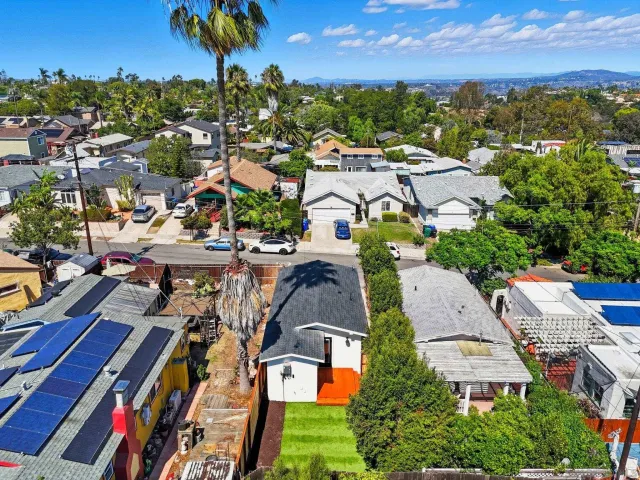 an aerial view of residential houses with outdoor space and street view