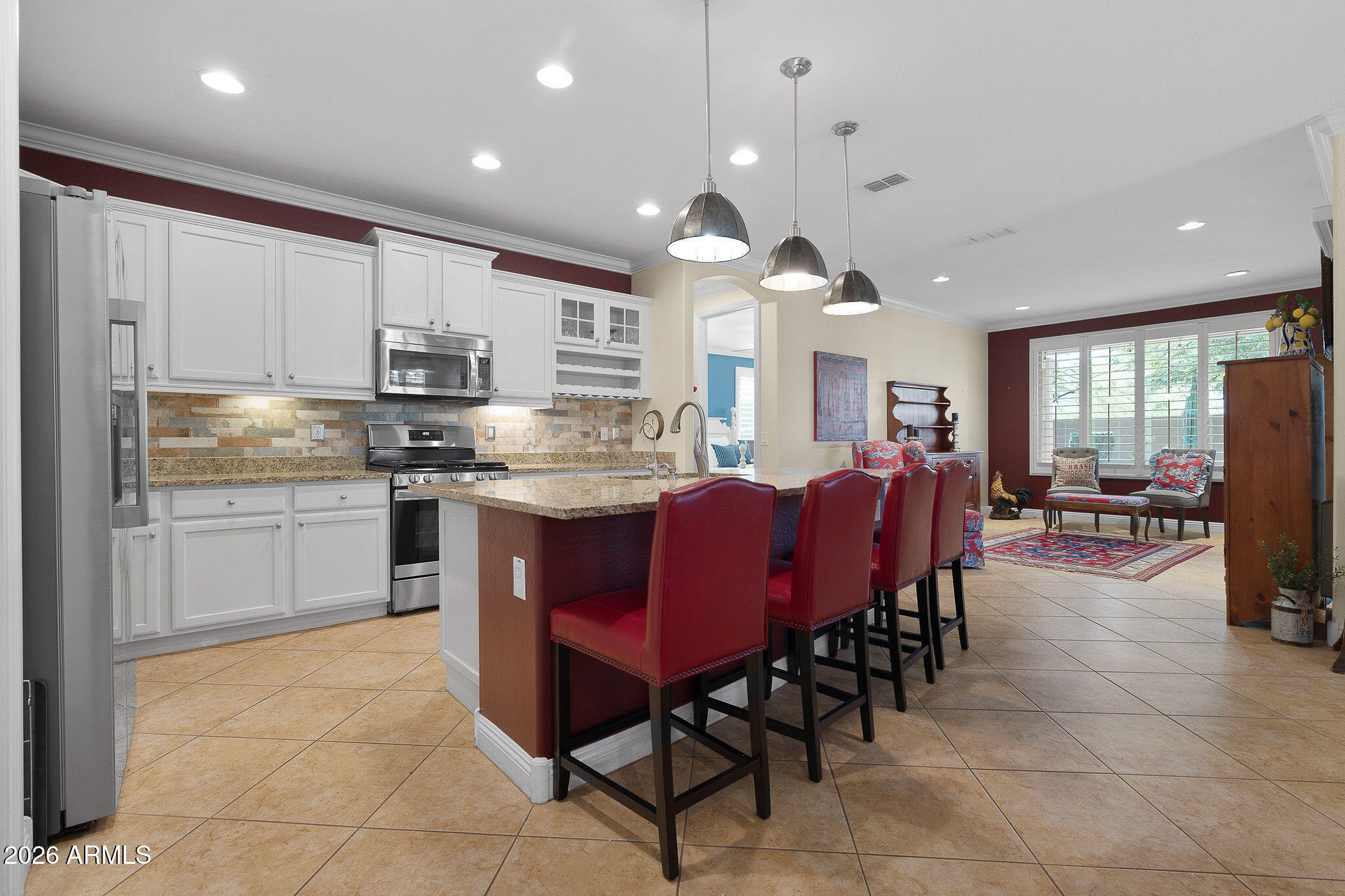7337 West Silver Spring Way Florence, AZ 85132 - Photo 24 of 60 a open kitchen with stainless steel appliances granite countertop a table chairs sink and cabinets